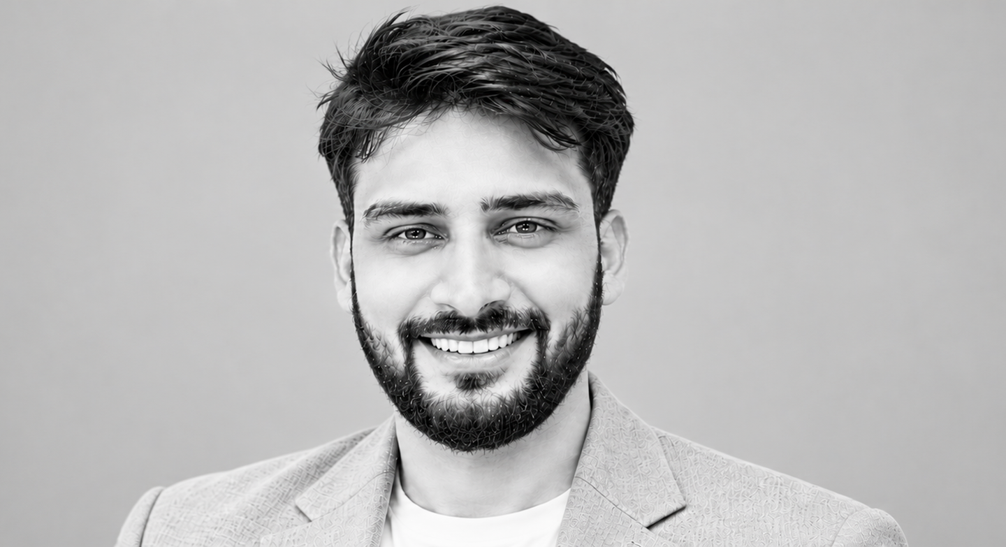 Suhas Zambare smiling in a light blazer
